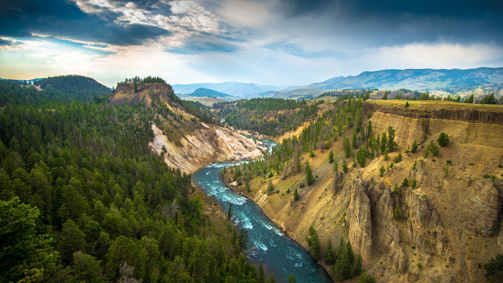 A view of a river flowing through a canyon surrounded by trees (yellowstone national park, grand canyon of the yellowstone, grand canyon national park, national park, yosemite national park)