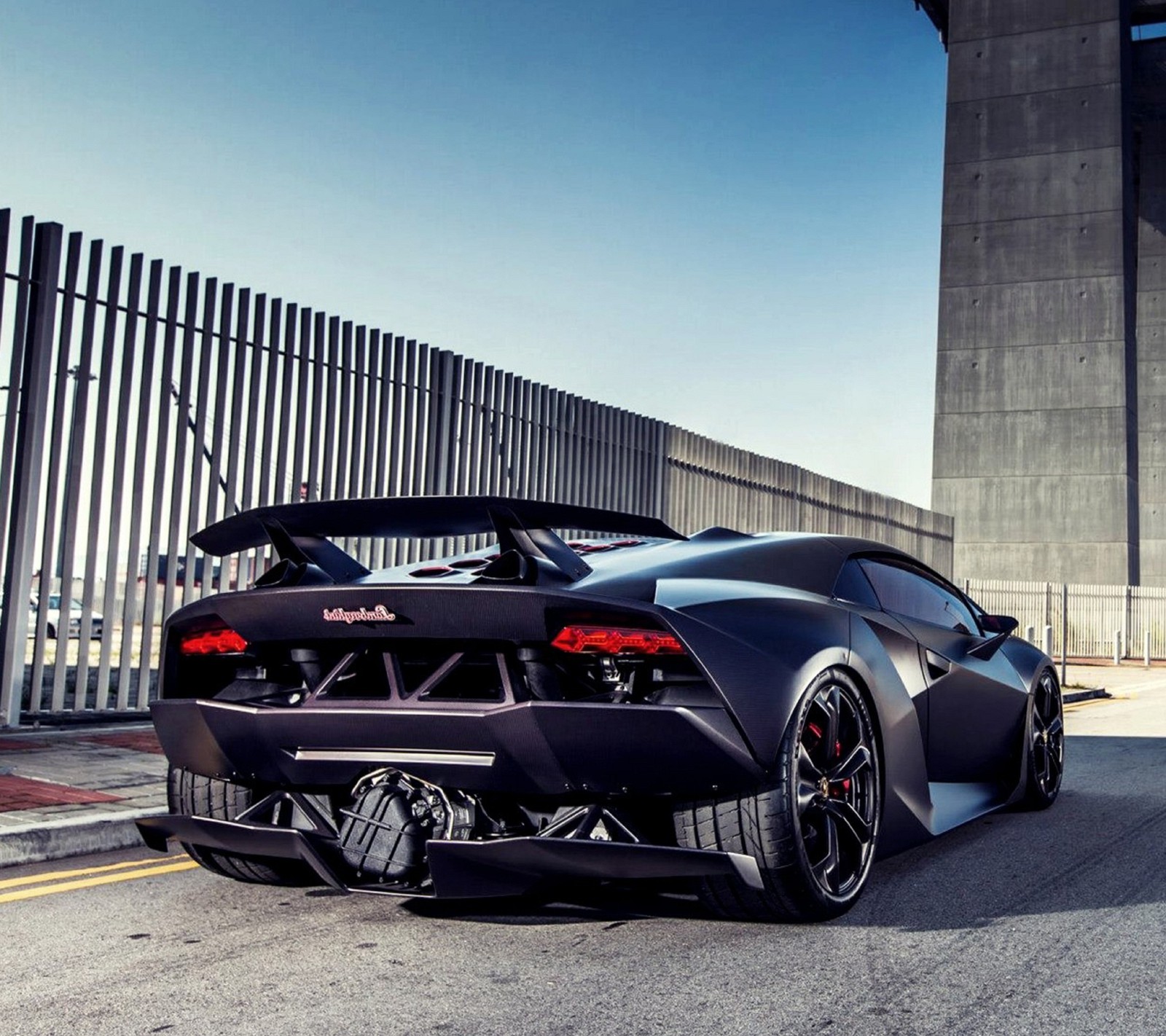 A close up of a black sports car parked on a street (aventador, bmw, dodge, ferrari, lamborghini)