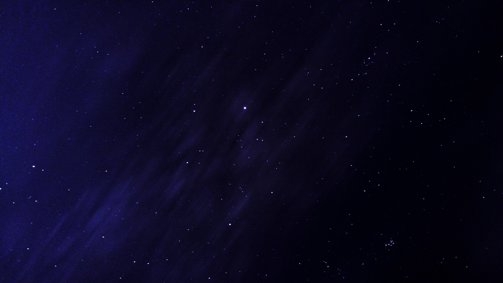 A close up of a plane flying through a dark blue sky (night sky, star, astronomy, night, astrophotography)