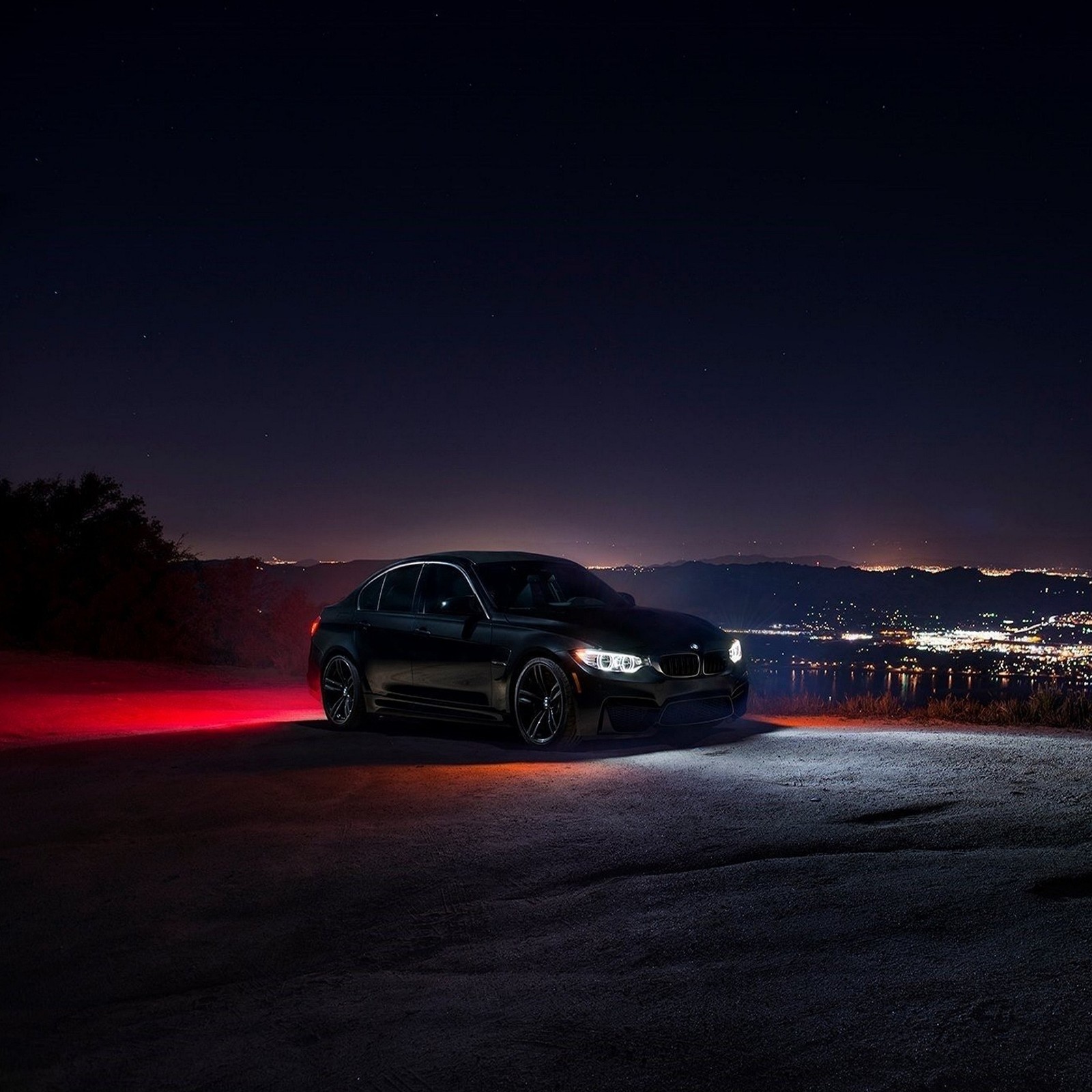 A close up of a bmw suv parked on a road at night (auto, bmw, car, m3)