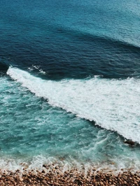 Turquoise Waves Crashing on a Rocky Shoreline