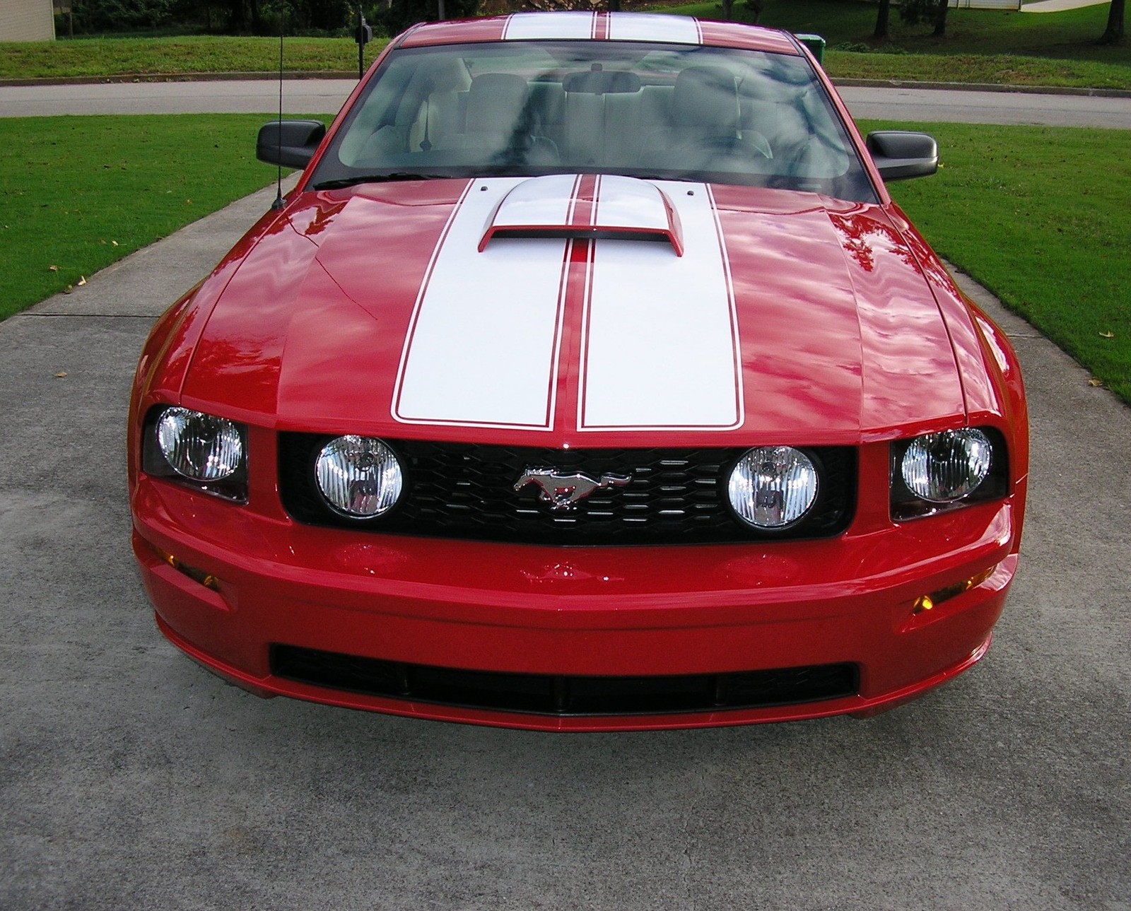 Arafed red mustang with white stripes parked in a driveway (car, ford mustang, vehicle)