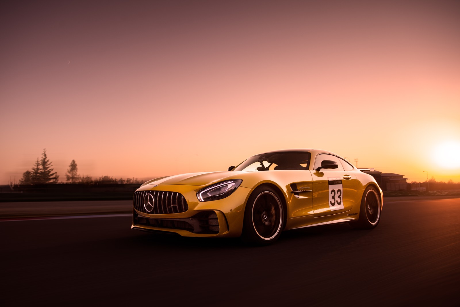 A close up of a yellow sports car driving on a road (sports car, supercar, wheel, concept car, compact car)