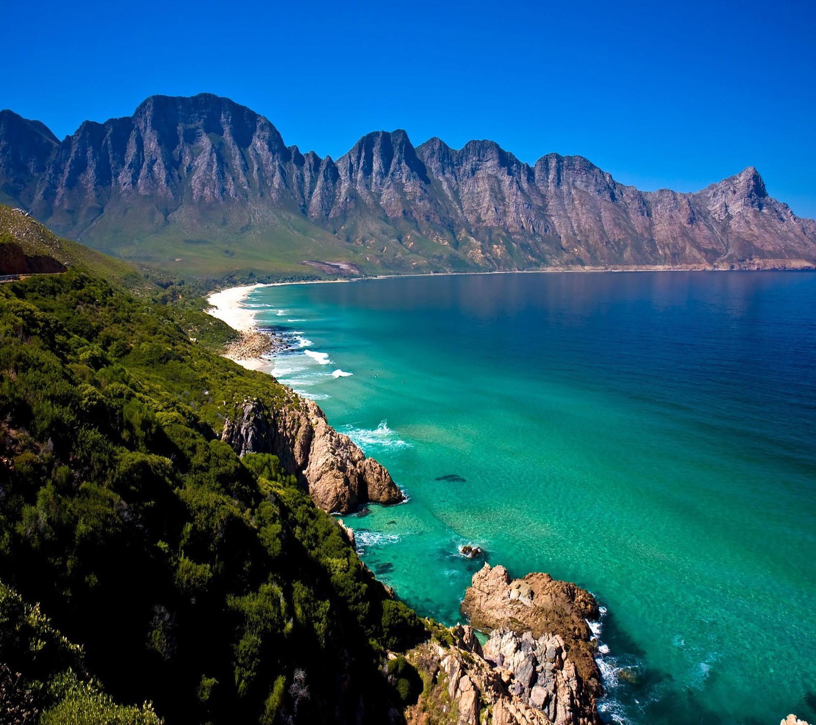 Mountains and blue water with a beach and a mountain in the background (beautiful, cute, look, nice)