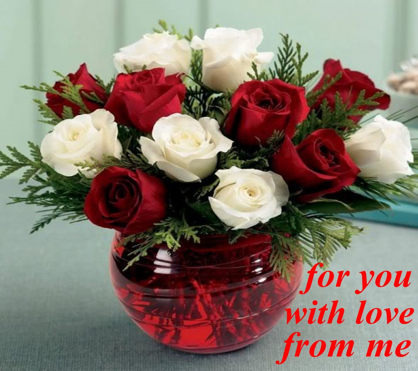 There is a red vase with white roses and pine branches in it (for you, with love)