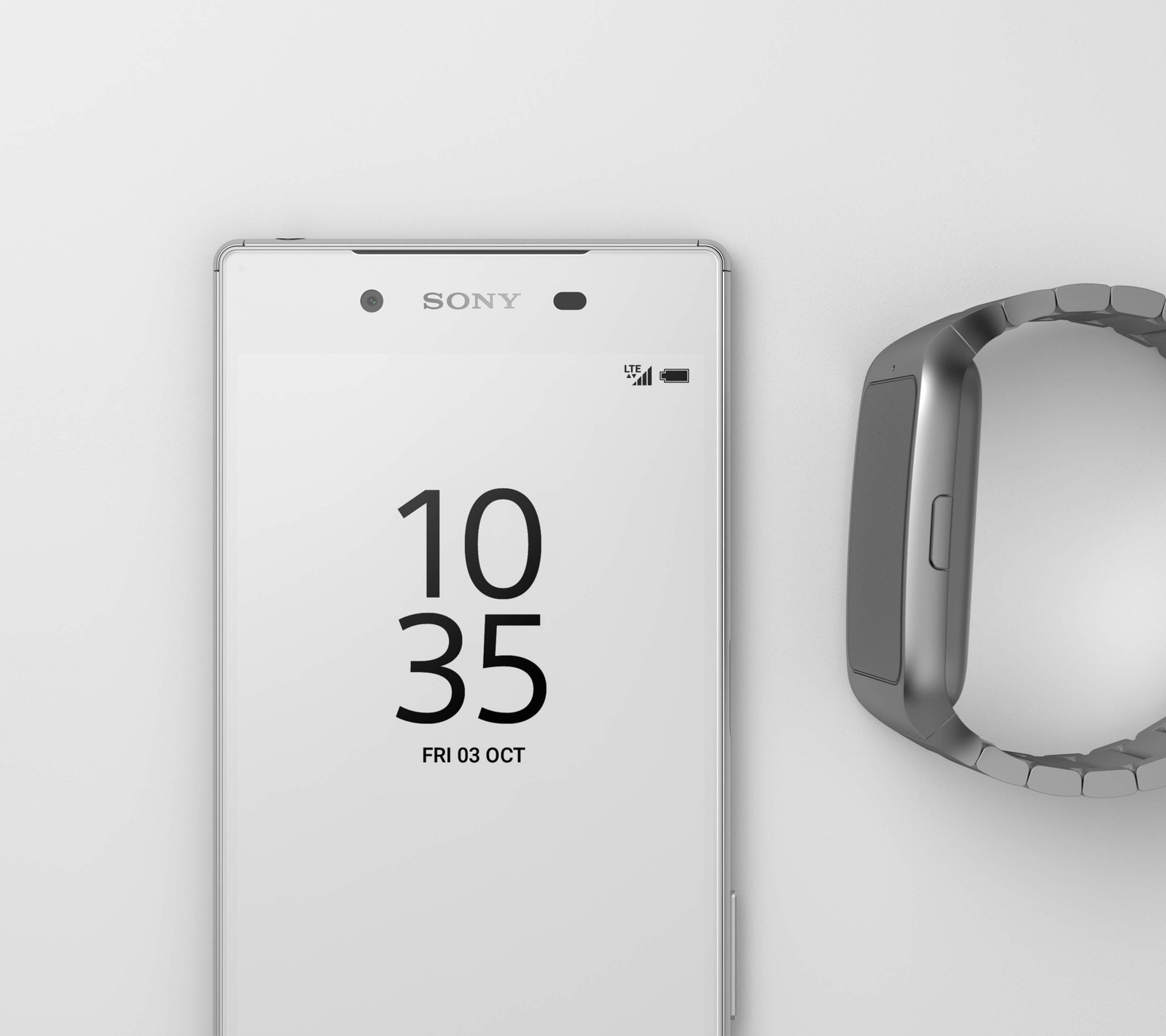 A close up of a smart phone with a wristband next to it (android, smartphone, smartwatch, sony, technology)