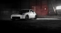 Sleek Nissan 350Z sports car showcasing stylish alloy wheels in a dramatic industrial setting.