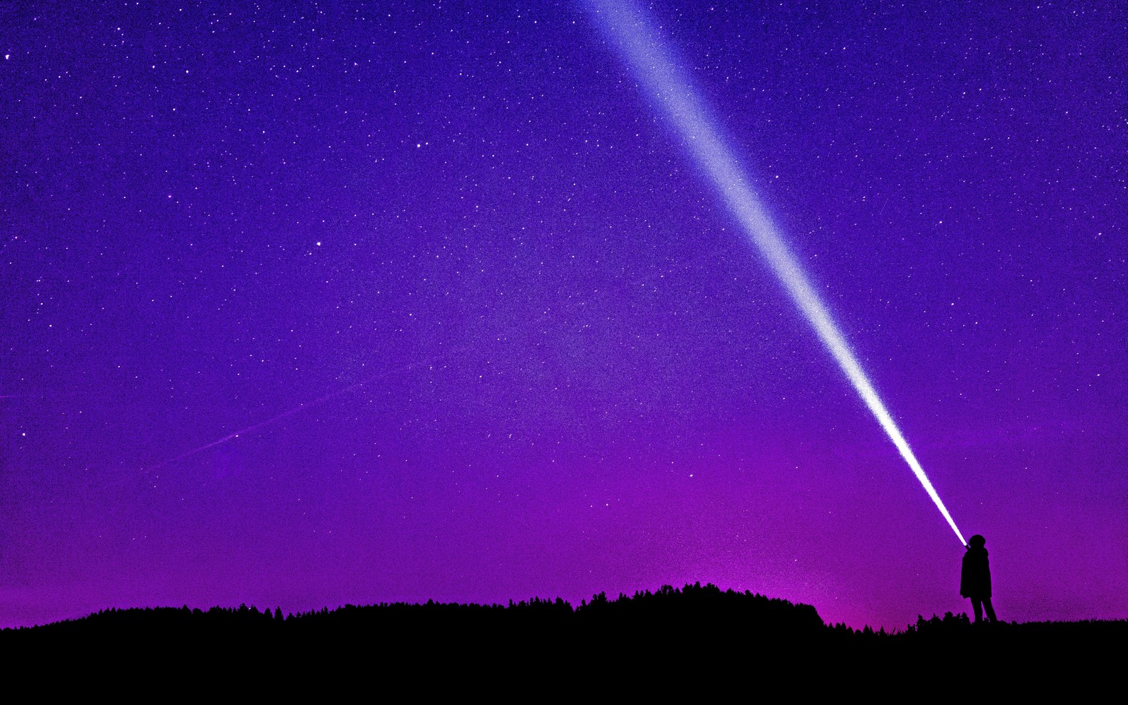 Arafed image of a person standing on a hill with a flashlight in their hand (violet, purple, atmosphere, night, space)