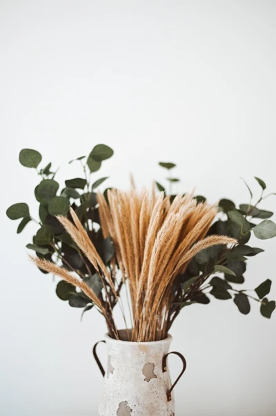 Dried Floral Arrangement in Rustic Vase with Greenery