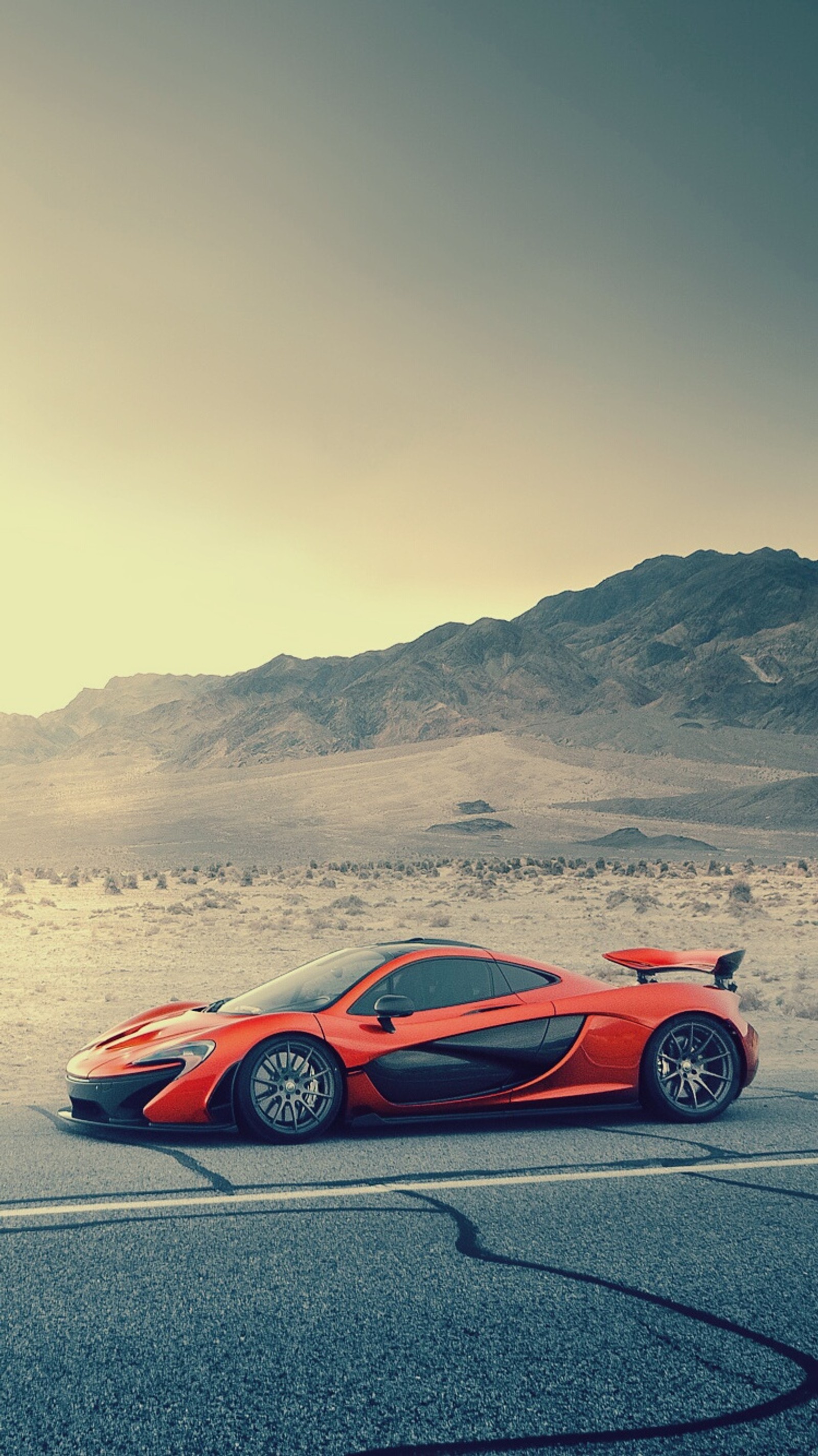 Un coche deportivo en una carretera desértica con montañas al fondo (coche, mclaren, p1, supercoche, vehículo)