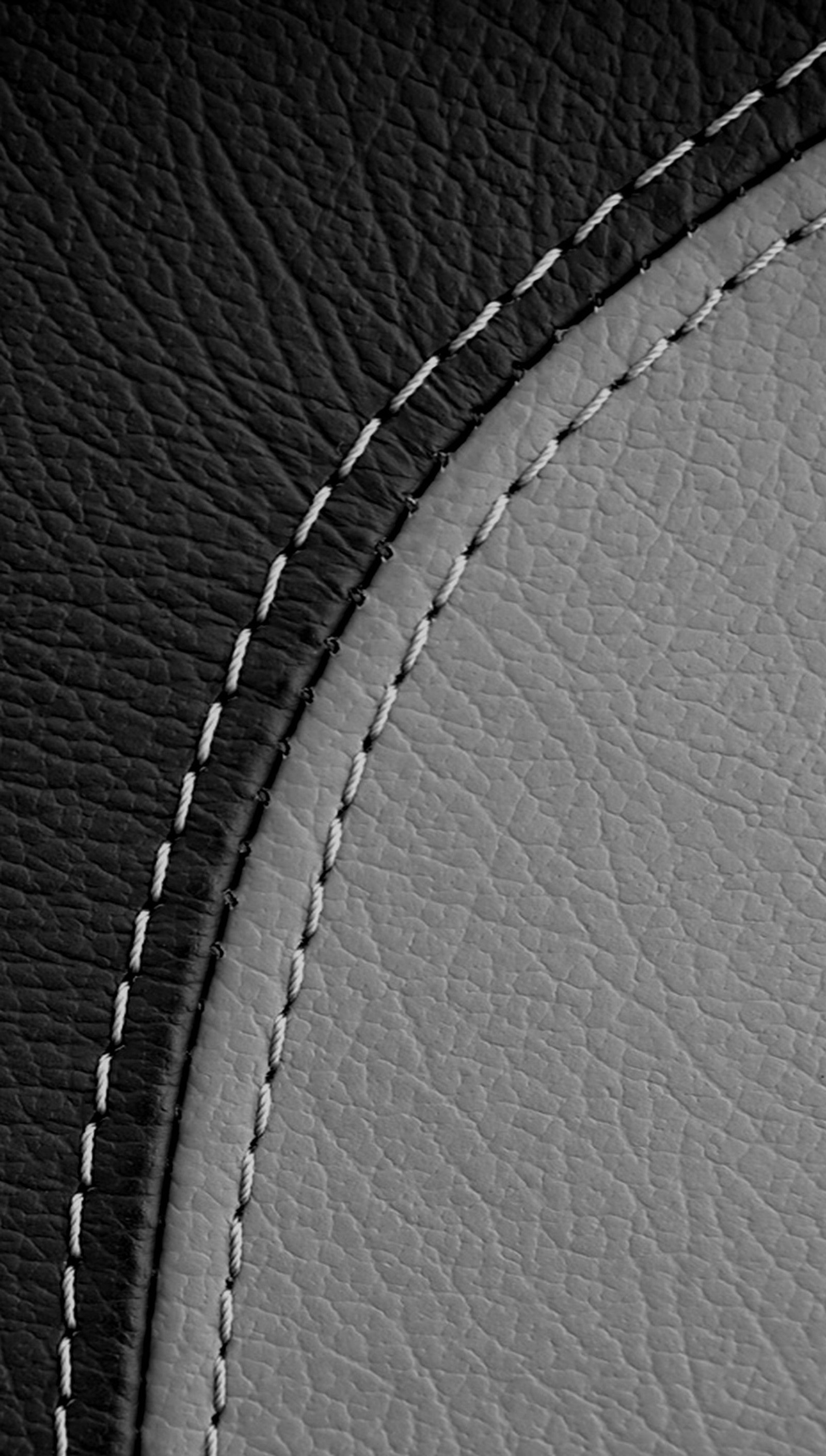 A close up of a black and white photo of a leather surface (abstract background, stitching leather)