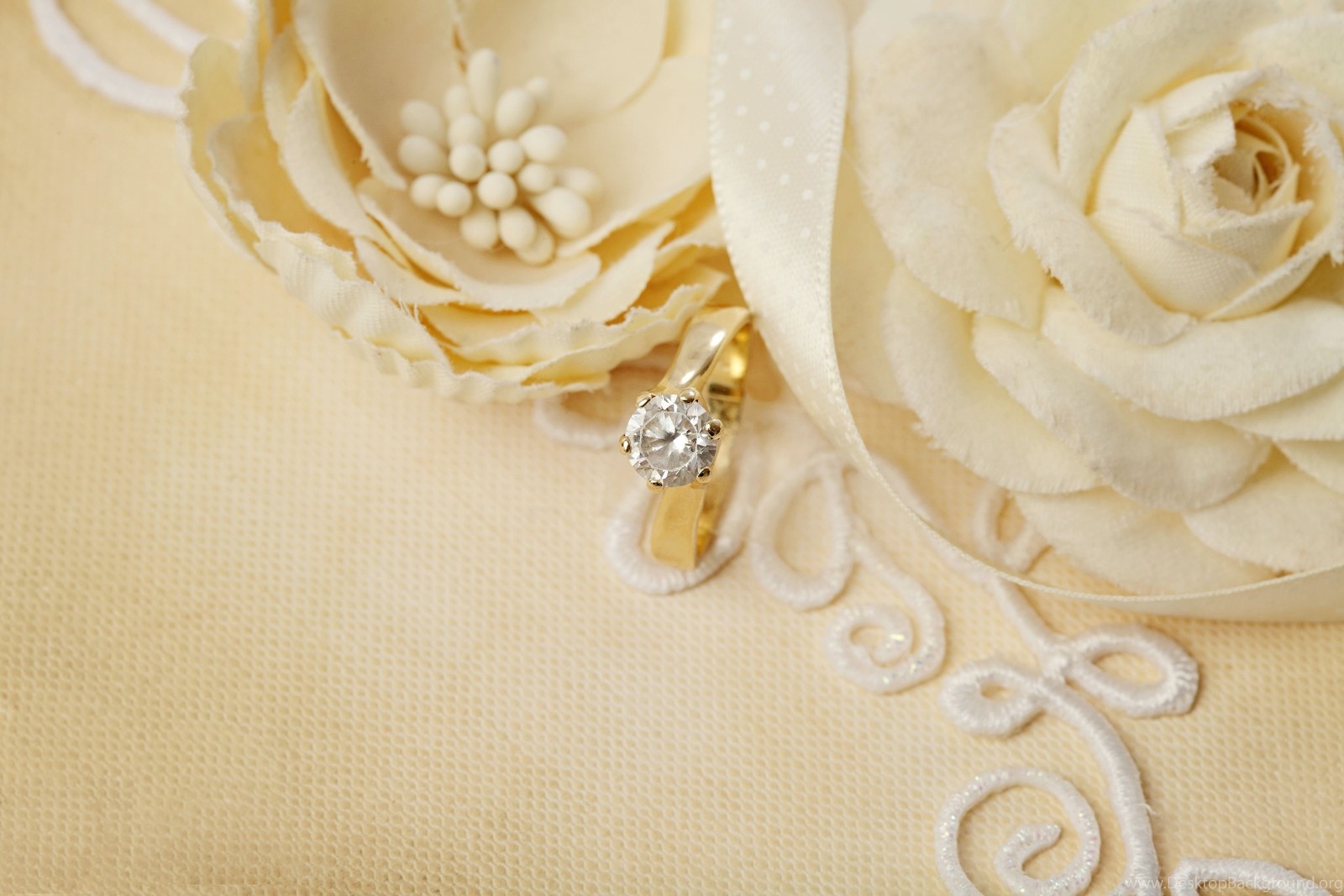 There is a wedding ring on a white flower on a table (wedding ring, wedding, ring, fashion accessory, body jewelry)